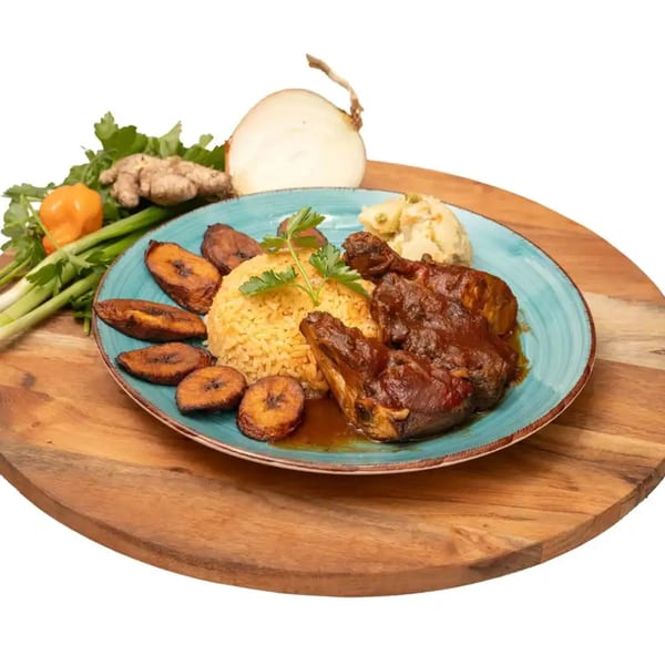 Caribbean jerk chicken with rice, fried plantains, and potato salad on a blue plate.